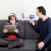Dad shouting at son with bullhorn